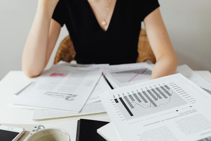 Swiss accountant reviewing monthly bookkeeping ledgers for a foreign-owned GmbH