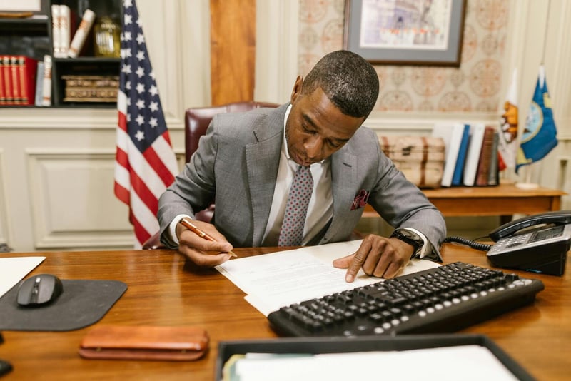 Lawyer signing document at office desk — Swiss contact-person mandate