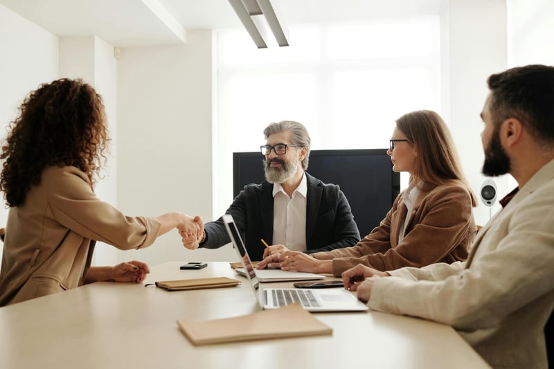 Business handshake in boardroom — Swiss M&A advisory and SPA drafting