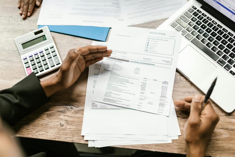 Payroll spreadsheet and calculator on desk — Swiss payroll administration